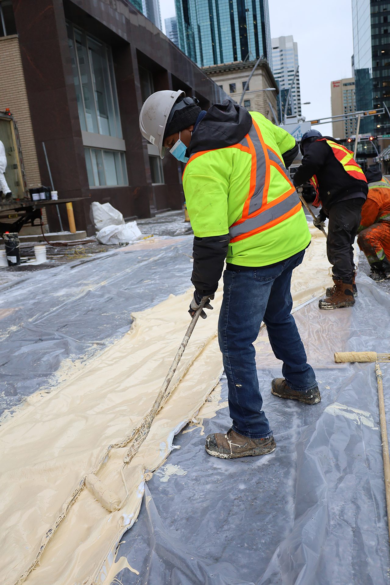 A crew saturating a liner on site