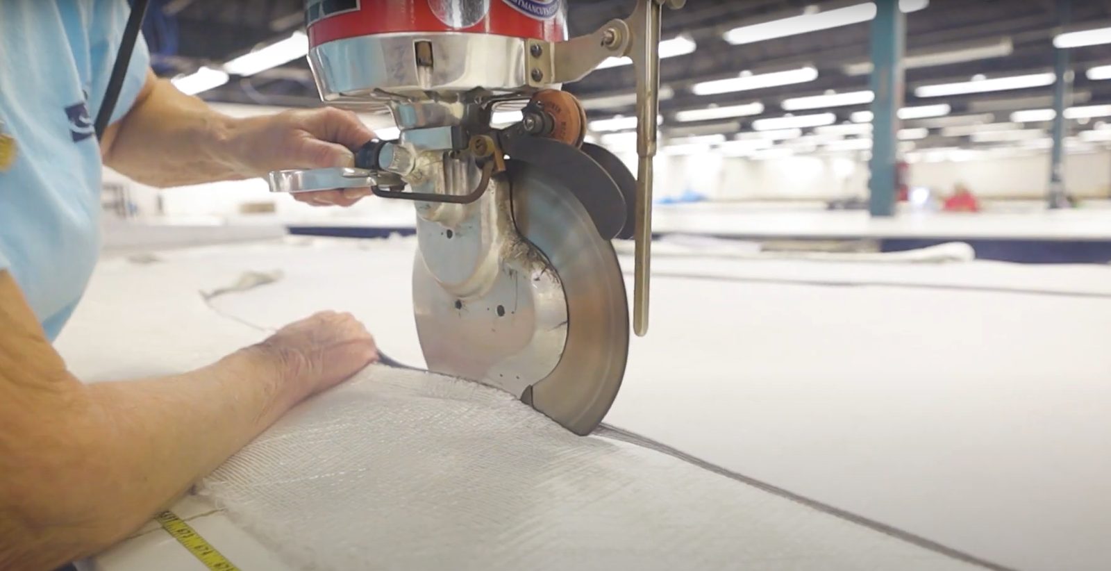 Fiberglass being cut to measure at the factory